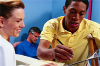 Man signing clipboard