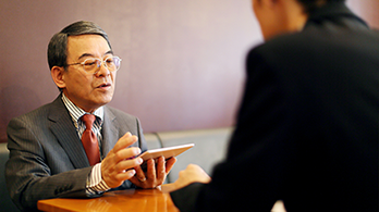 man talking while looking at tablet