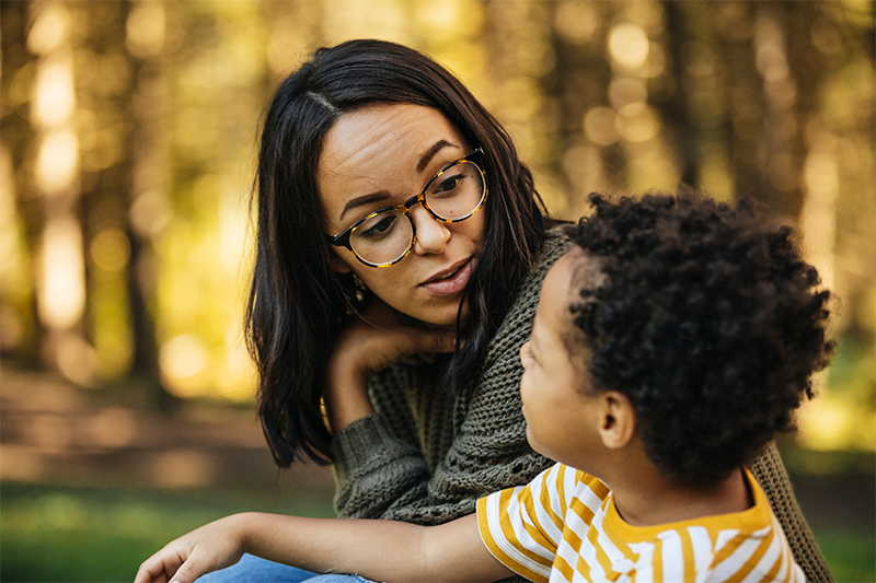 woman with small child sitting outside