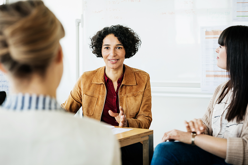 three women sitting and talking