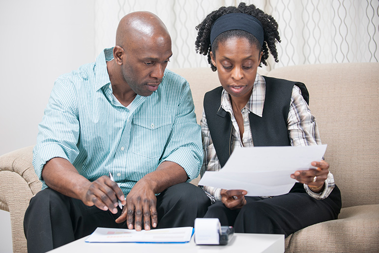 photo of couple looking at papers