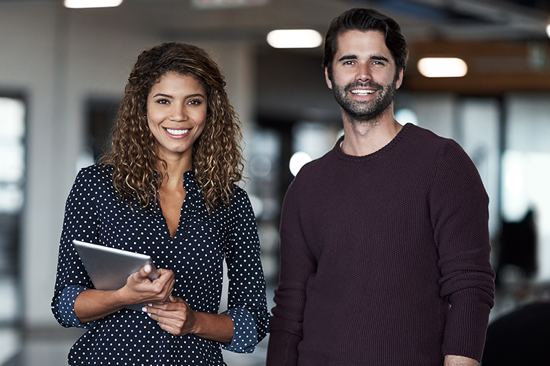 man and woman in business attire holding coffee