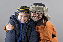 man hugging young boy and smiling