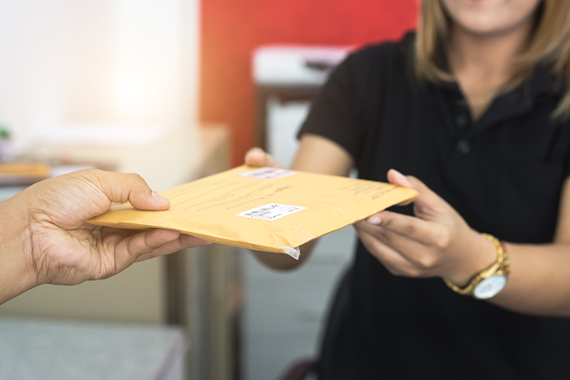 mail being passed between two people